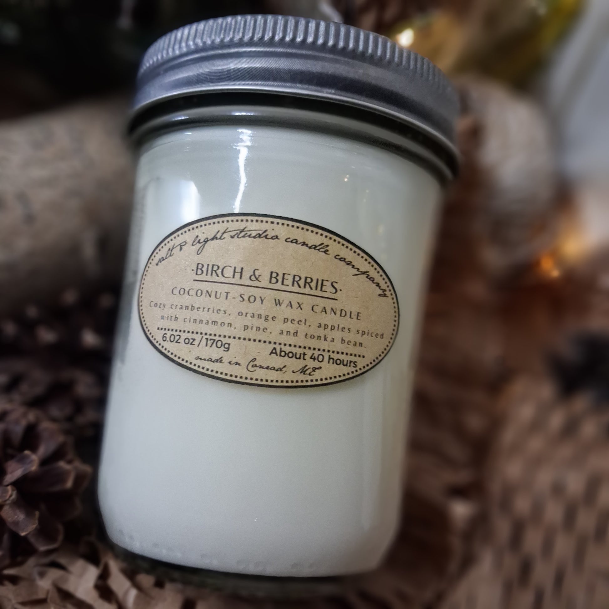 Farmhouse style candle in a glass mason jar; coconut soy wax candle scented with cranberries, orange peel, apples, spices, pine, and tonka bean: Birch & Berries 