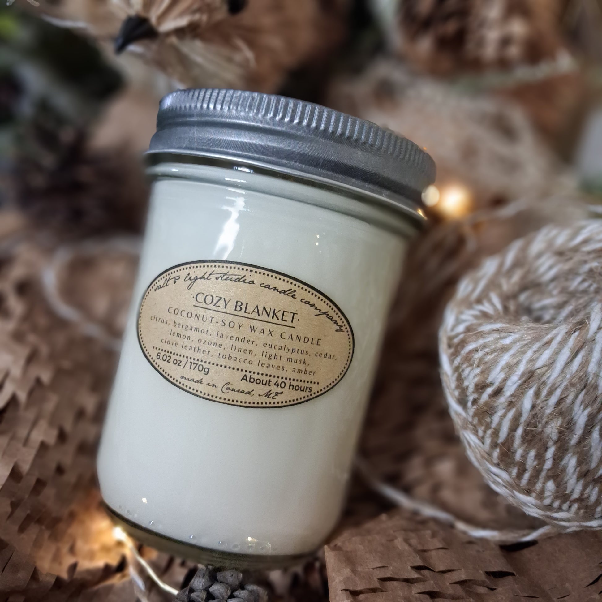 Candle jar with a label on a woven wrapping paper and jute twine; lavender and bergamot coconut soy candle